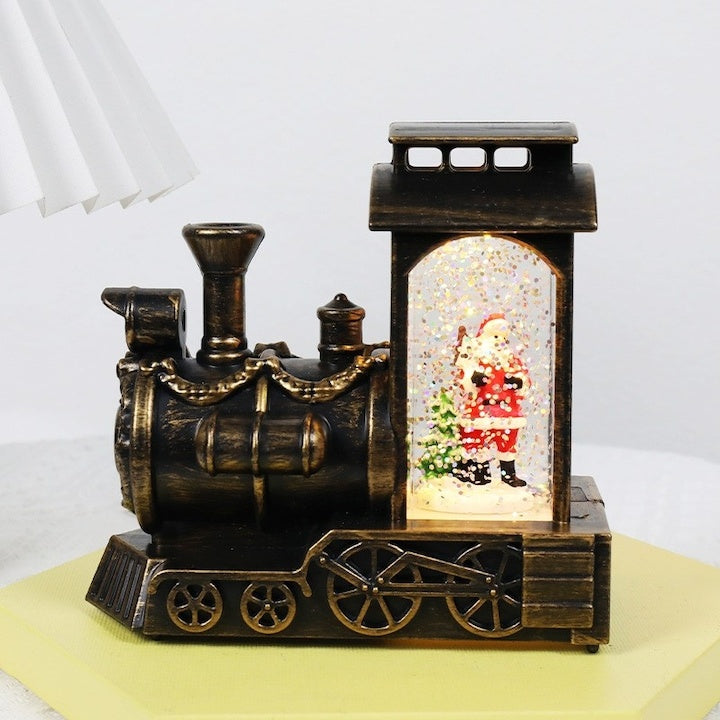 Decoratiune de Craciun tip locomotiva, glob de cristal cu fulgi de zapada, model Mos Craciun, iluminare LED, 11.5 x 12.5 x 6 cm, muzical, maro